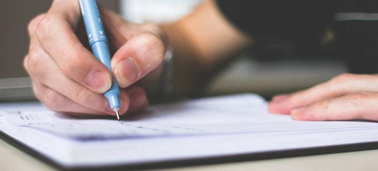 A person creating a plan for unpacking a portable storage container