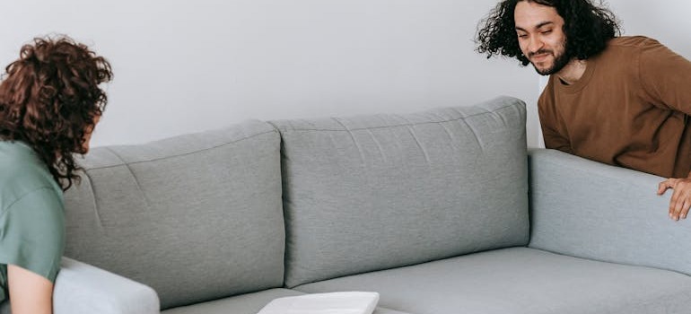 A couple moving a sofa
