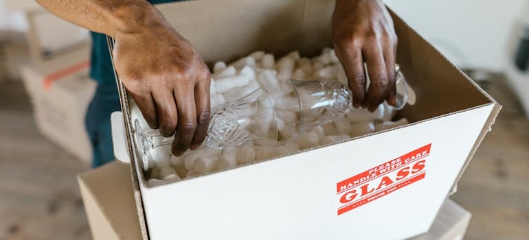 A person unpacking glasses