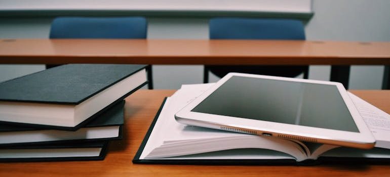 Silver Ipad on White Book Page