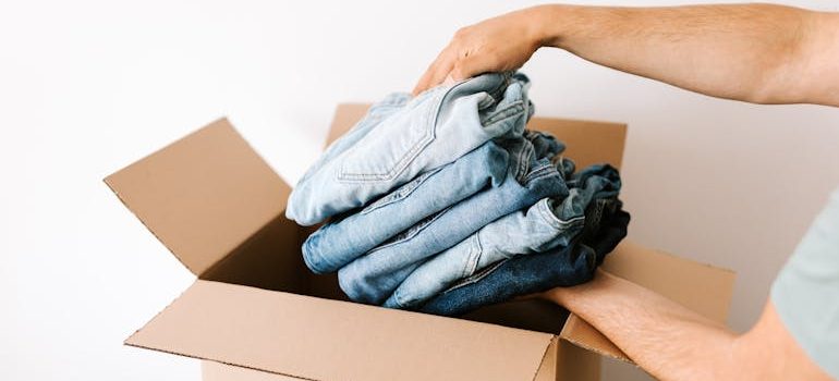 packing casual clothes into carton box