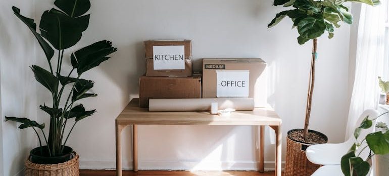 Brown Cardboard Boxes on Wooden Table