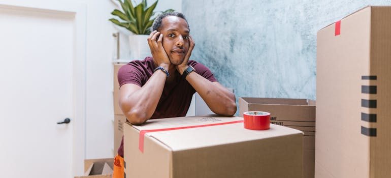 A Man Resting on a Sealed Box